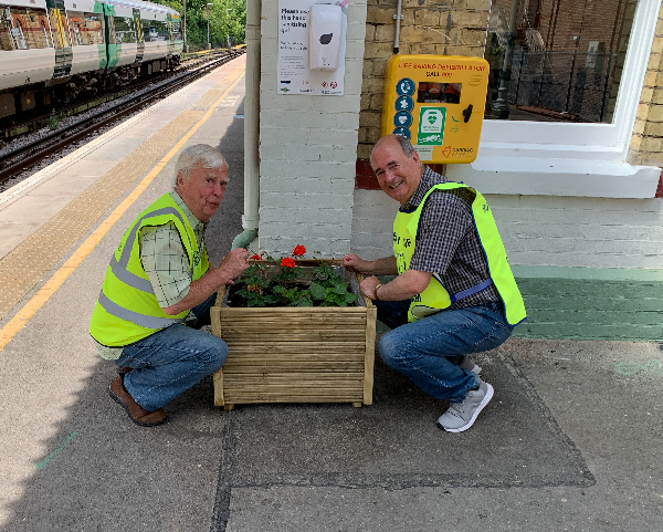 Rotarians Peter Freebody and Malcolm Russell with one of the new planters at Caterham station