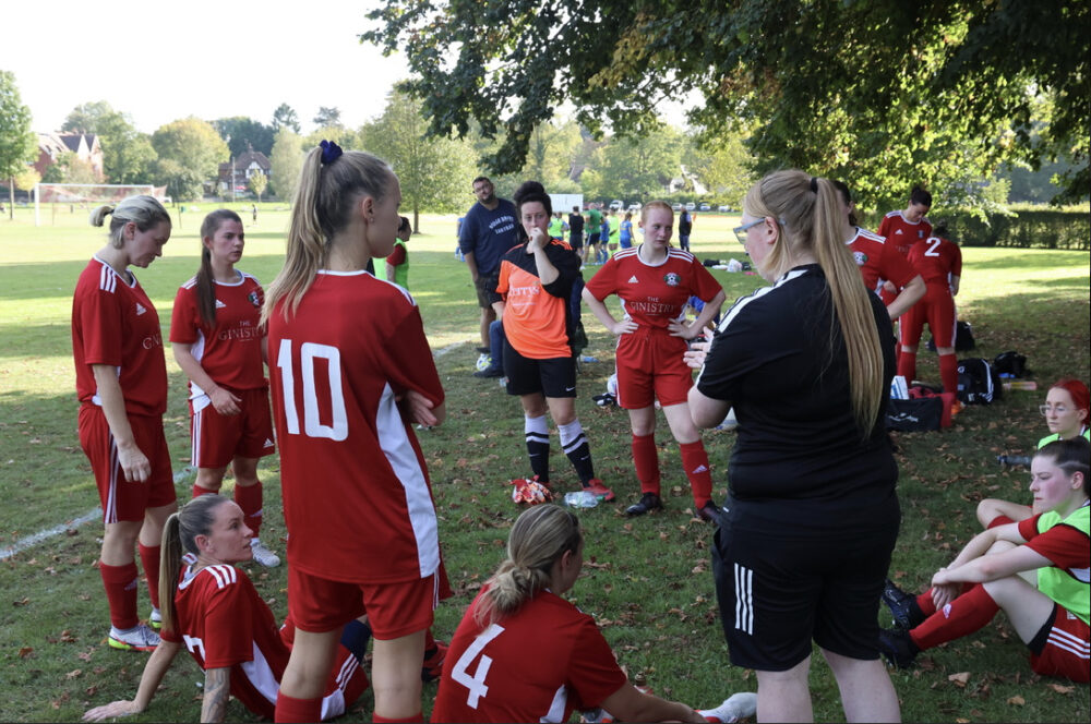 Oxted Womens FC have a half-time talk during their match against Reigate