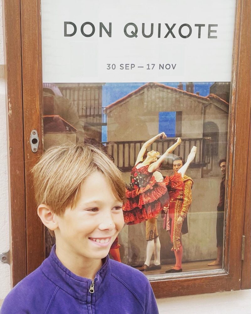 Sebastian Whitlock standing by a Don Quixote poster