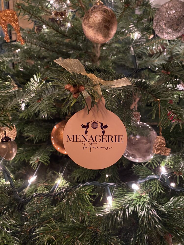 A bauble on a Christmas Tree with Menagerie Interiors written on it