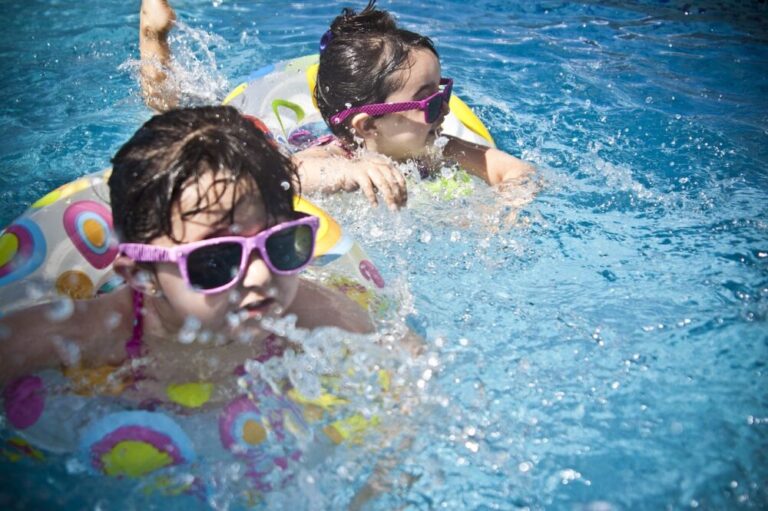 Children swimming in rubber rings in a pool
