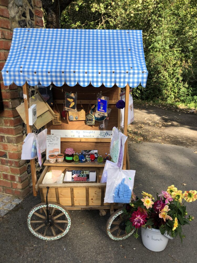A wooden trolley on wheels called the Charity Wagon, which is located in Tatsfield