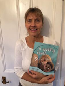 Author Janice Akhtar with her book, A Wobbly Tooth